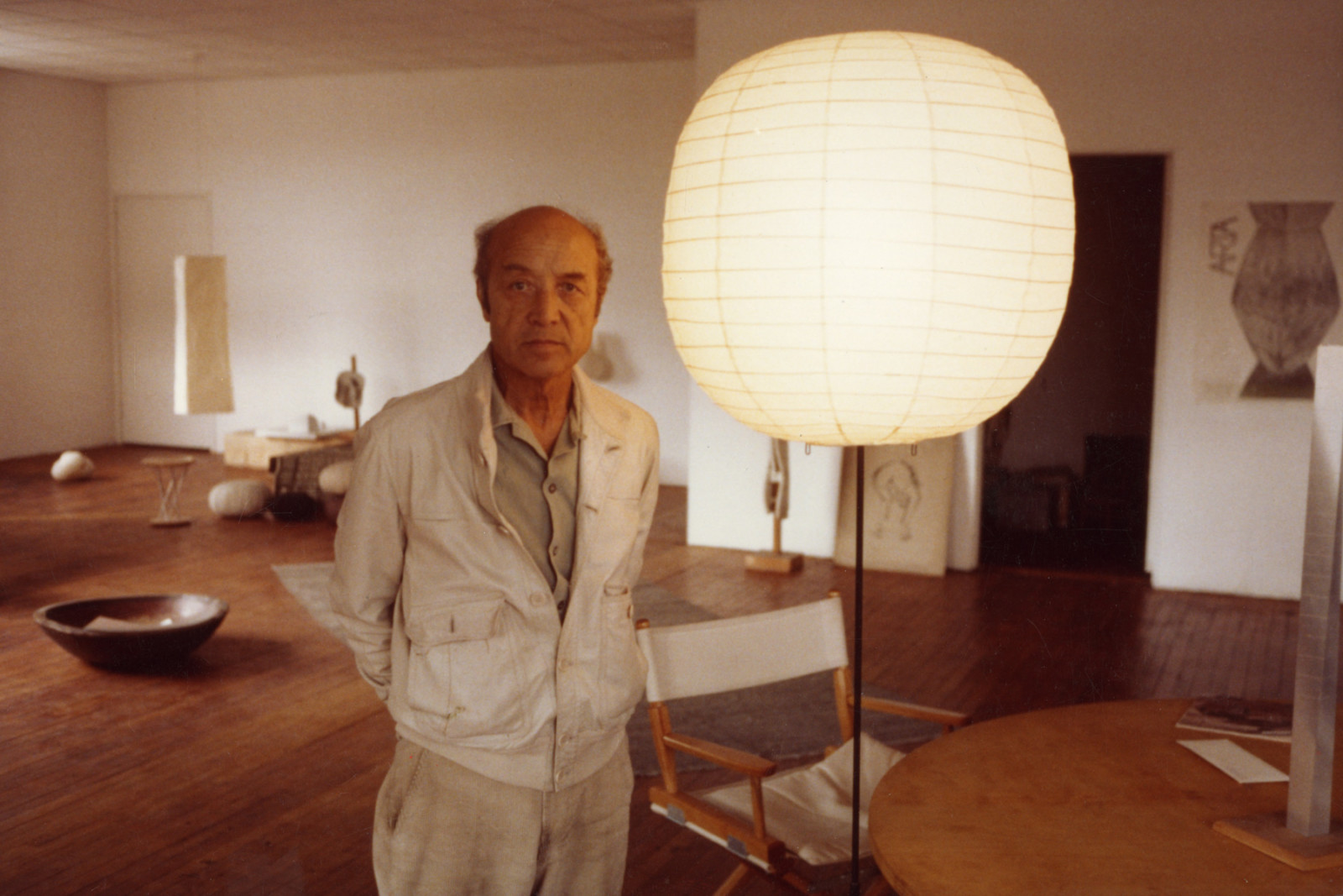 Isamu Noguchi with Akari and other sculptures in his Long Island City studio, c. 1980s.